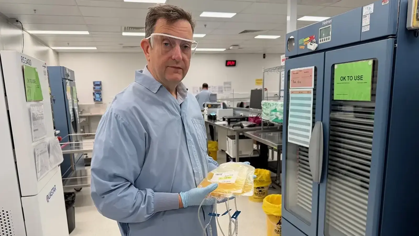 Prof Michael Reade holding bag of platelets at RC Lifeline Brisbane (credit University of Queensland). 