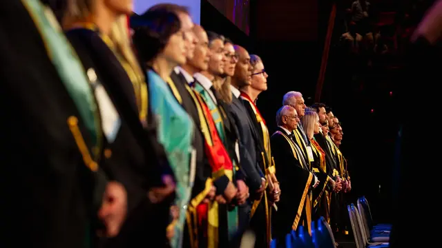 ANZCA and FPM fellows on stage in their gowns