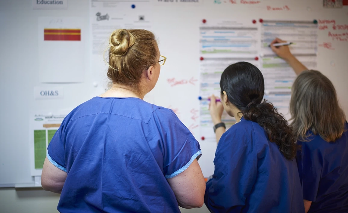 A team of healthcare professionals collaborates on a clinical research board, analyzing data and refining protocols to enhance patient outcomes in anaesthesia and perioperative care.