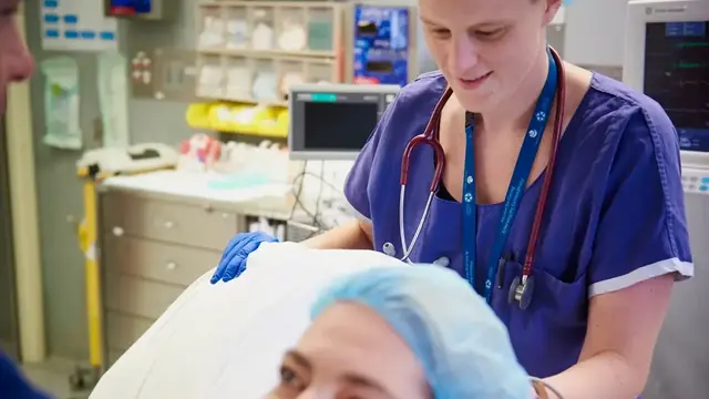 Doctor standing behind patient on bed