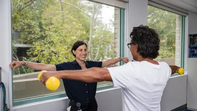 Doctor teaching patient physical exercises 