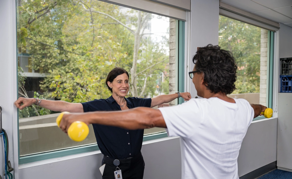 Doctor teaching patient physical exercises 