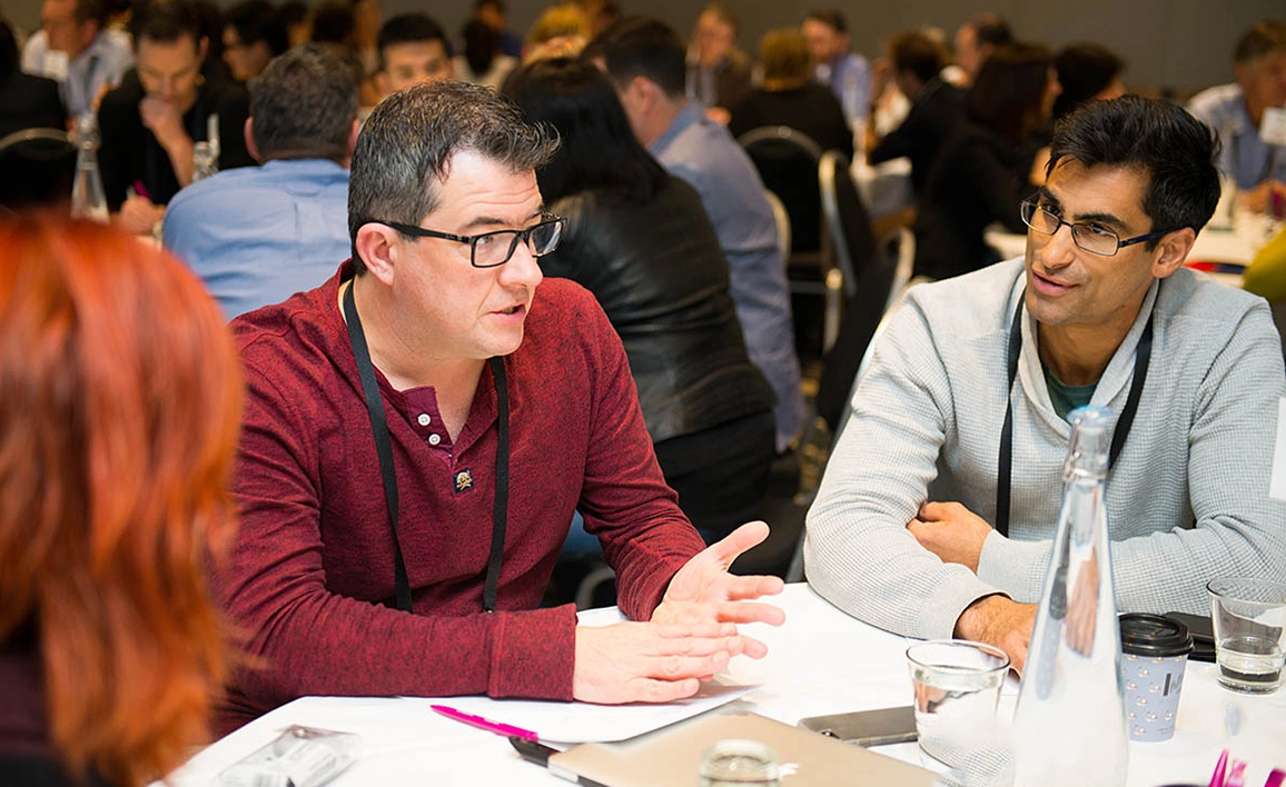 Professionals engaged in discussion around a table