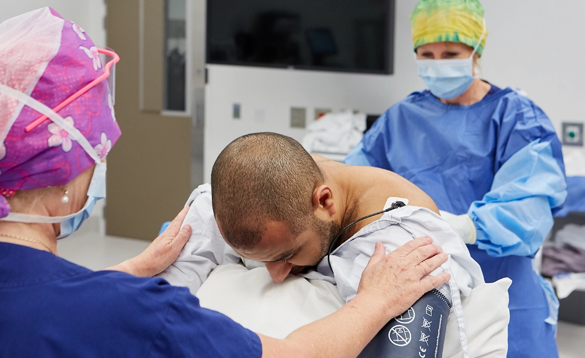 Two doctors conducting a procedure with a patient