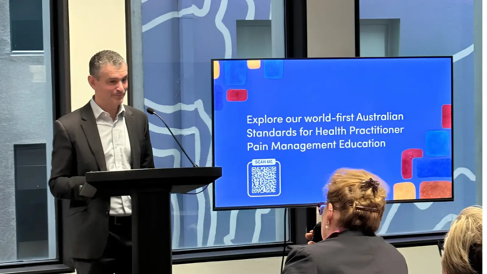 Dr Noam Winter presenting the standards at a podium