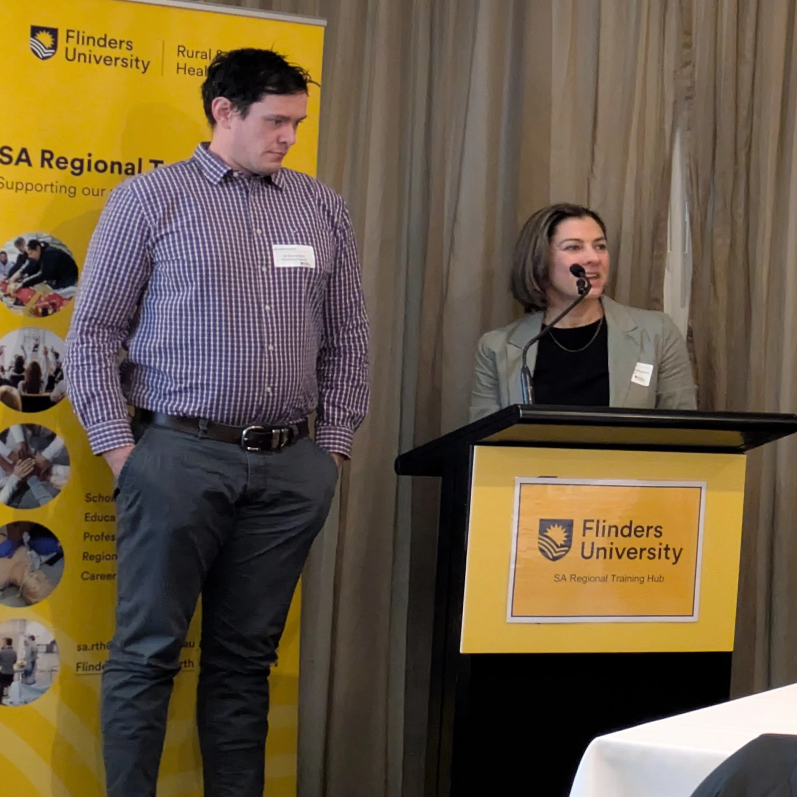 Two people standing at a lectern