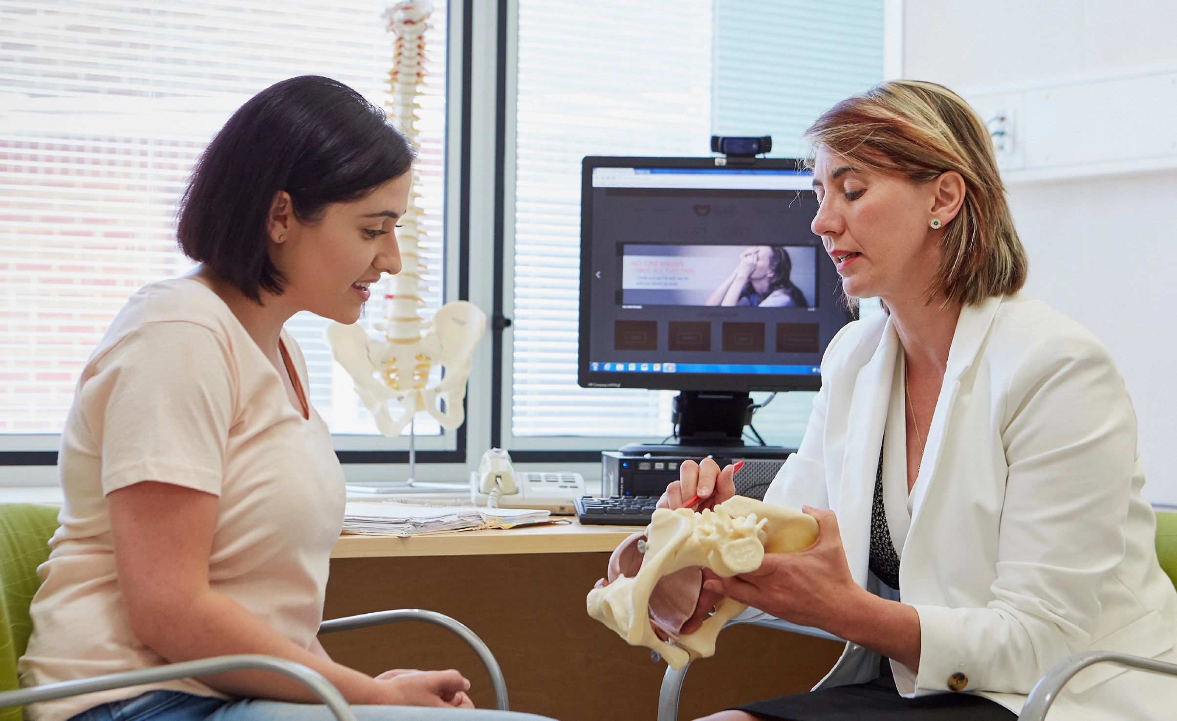 Specialist pain medicine physician talking to patient in clinic