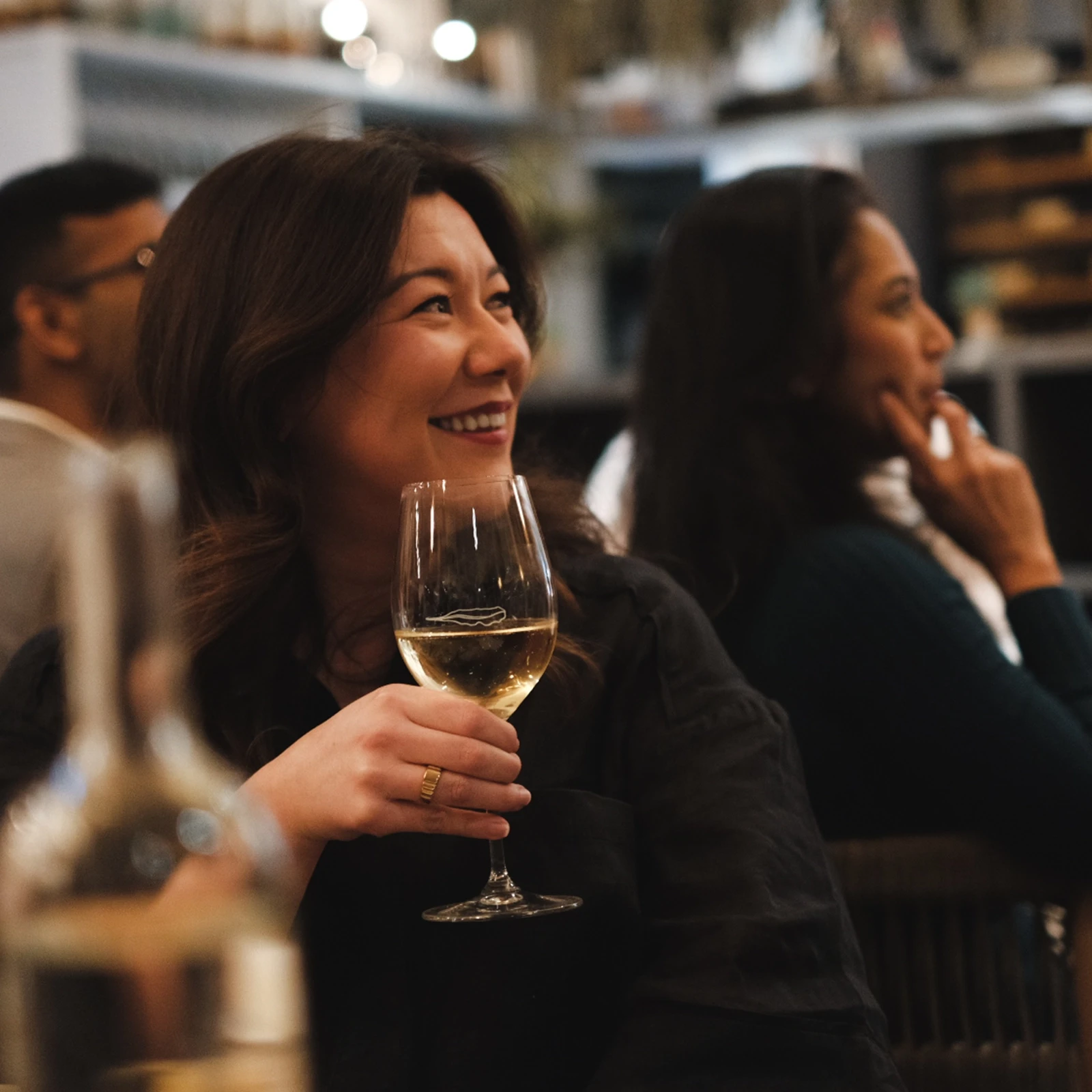 A person drinking a glass of wine