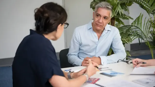 A man and a women talking in a meeting