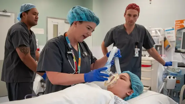Anaesthetist next to patient in operating theatre 