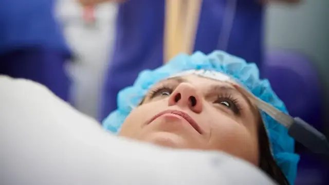 Female patient lying on operating table 