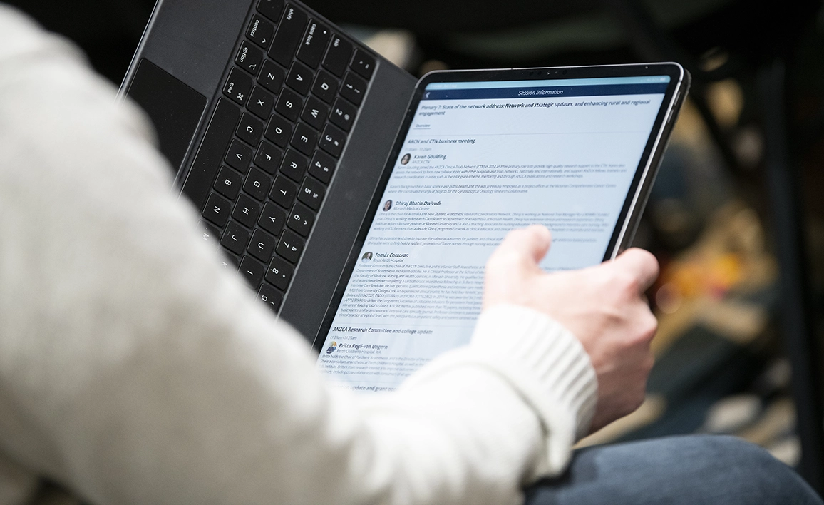 A person using a tablet with a keyboard reading a professional document.