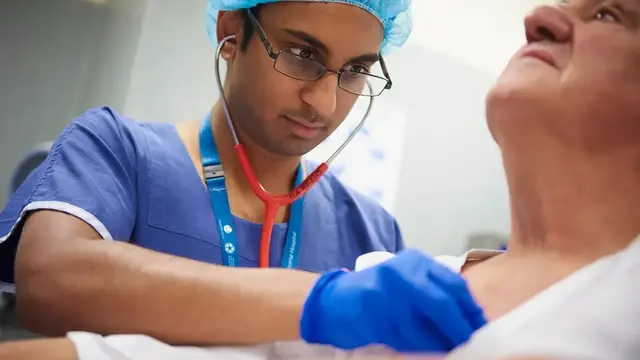 Doctor checking patient's heart 